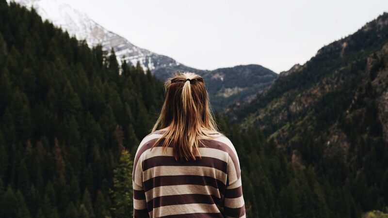 person staring at a mountain landscape