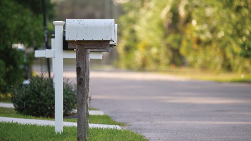 Typical american outdoors mail box on suburban street side.